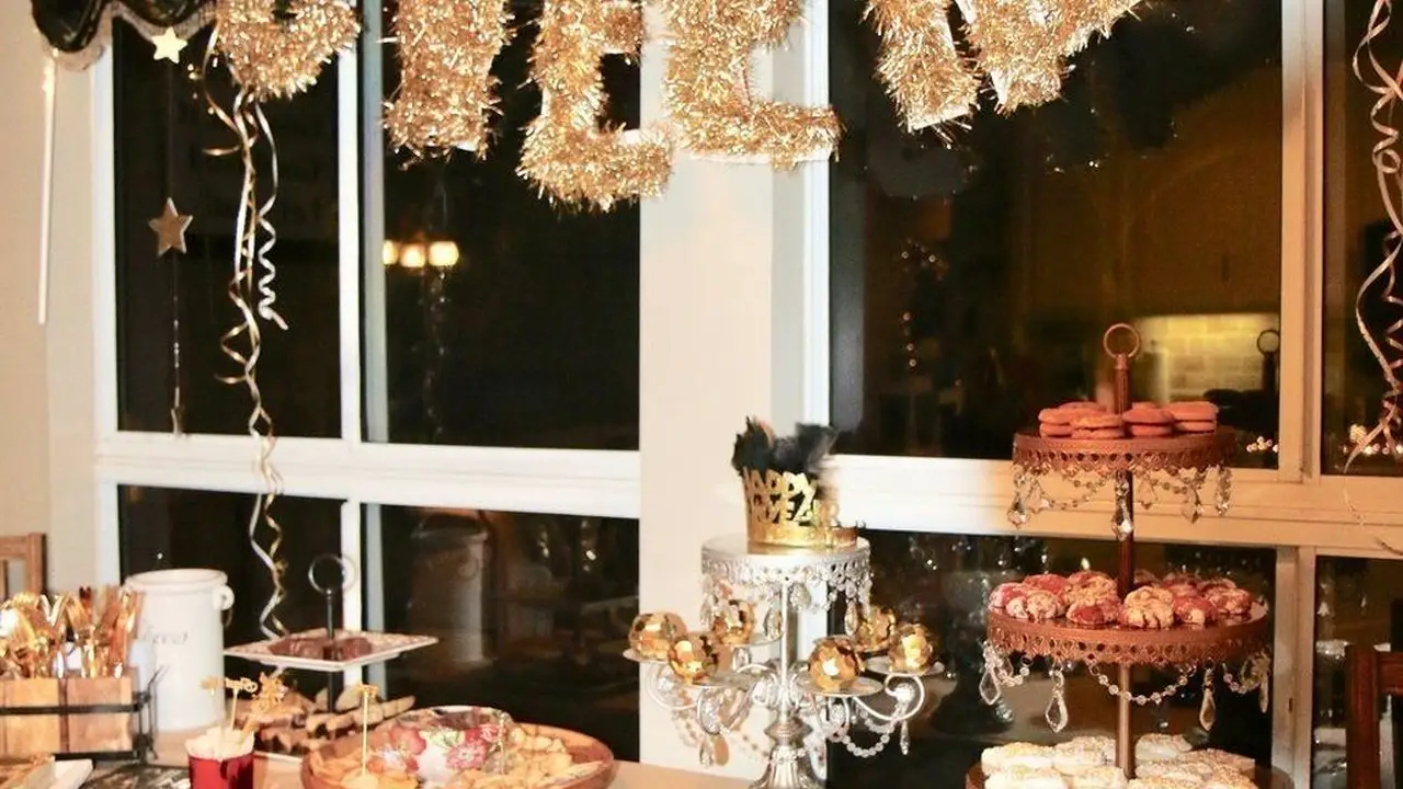 blue bowl of black bean beef tortilla soup on a board with cilantro and shredded cheese in background