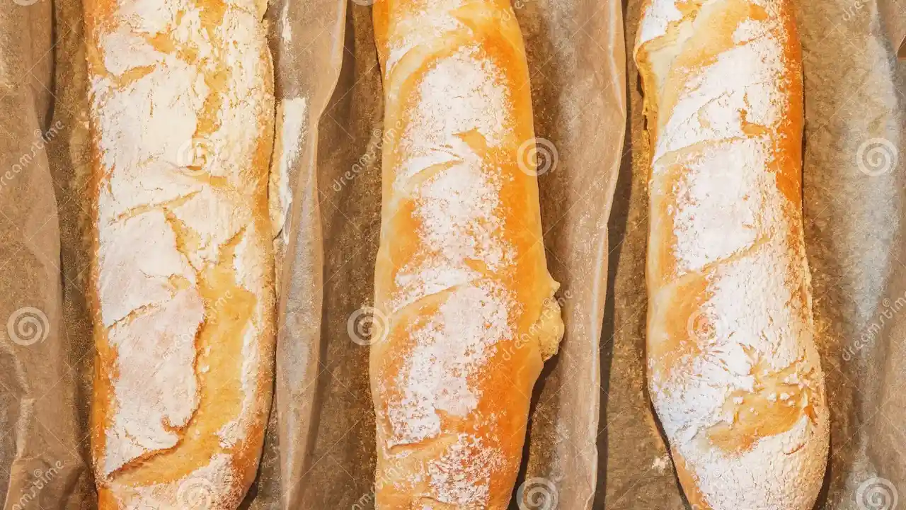 Close up on a plate of mashed potatoes, topped with baked pork chops with cream of mushroom soup, and a side of green beans.