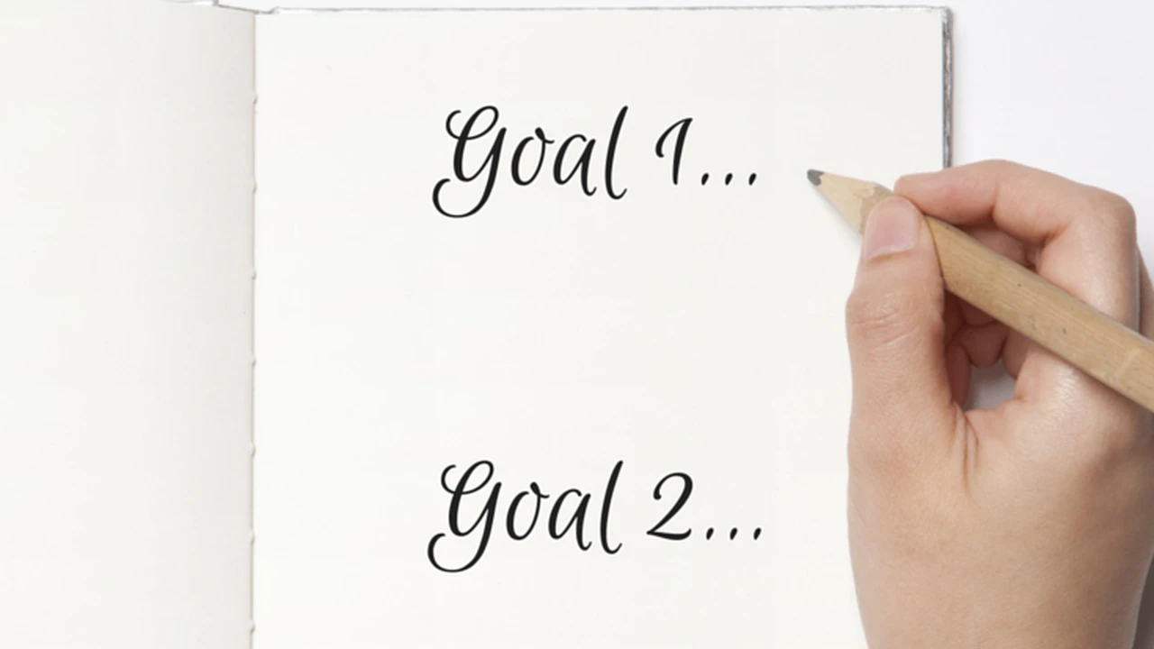 Close up on a plate of mashed potatoes, topped with baked pork chops with cream of mushroom soup, and a side of green beans.